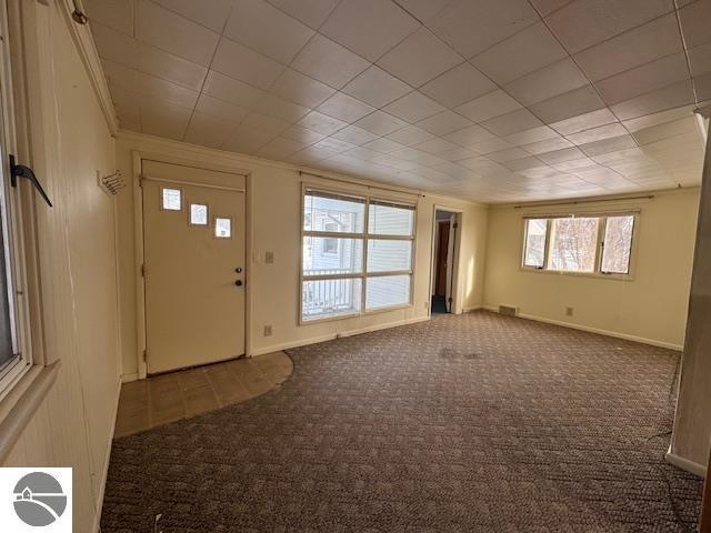 view of carpeted foyer entrance