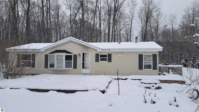 view of snow covered rear of property