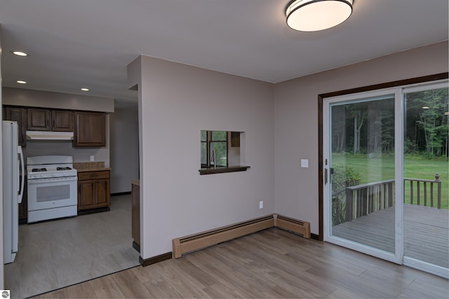 kitchen featuring light hardwood / wood-style floors, white appliances, and a baseboard heating unit