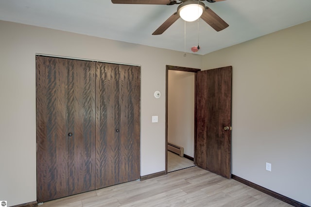 unfurnished bedroom featuring a closet, a baseboard radiator, ceiling fan, and light hardwood / wood-style floors