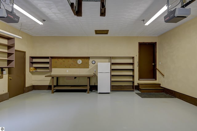 basement with a workshop area and white fridge