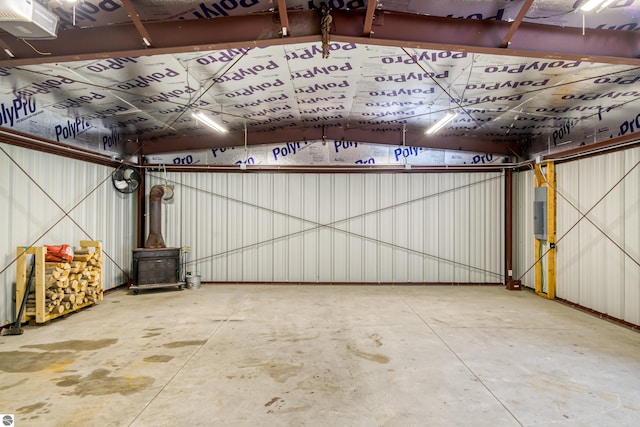 garage with a wood stove and a garage door opener