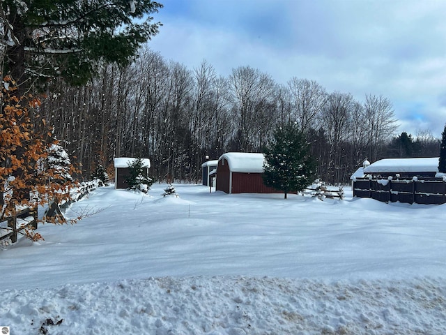 yard covered in snow featuring an outdoor structure