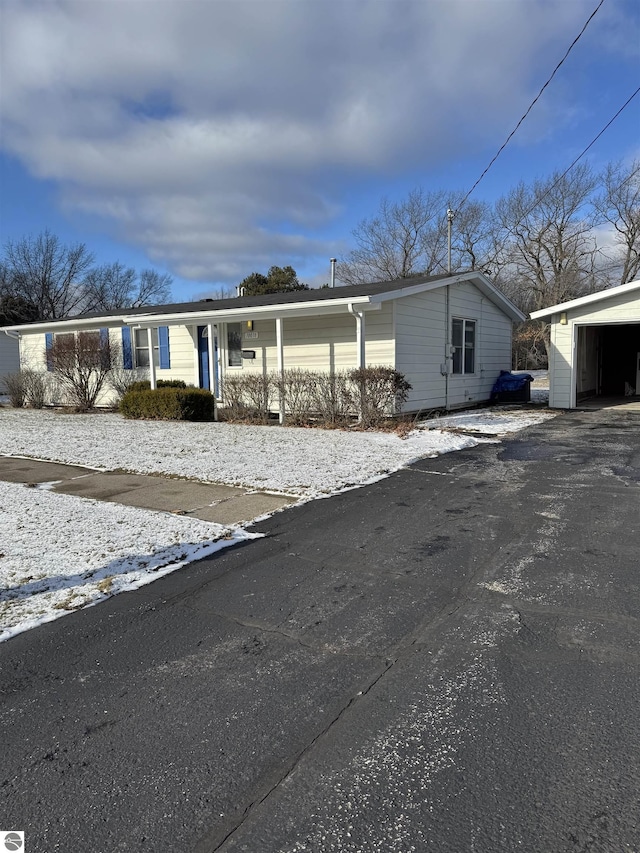 view of front of property with an outbuilding, a porch, and a garage