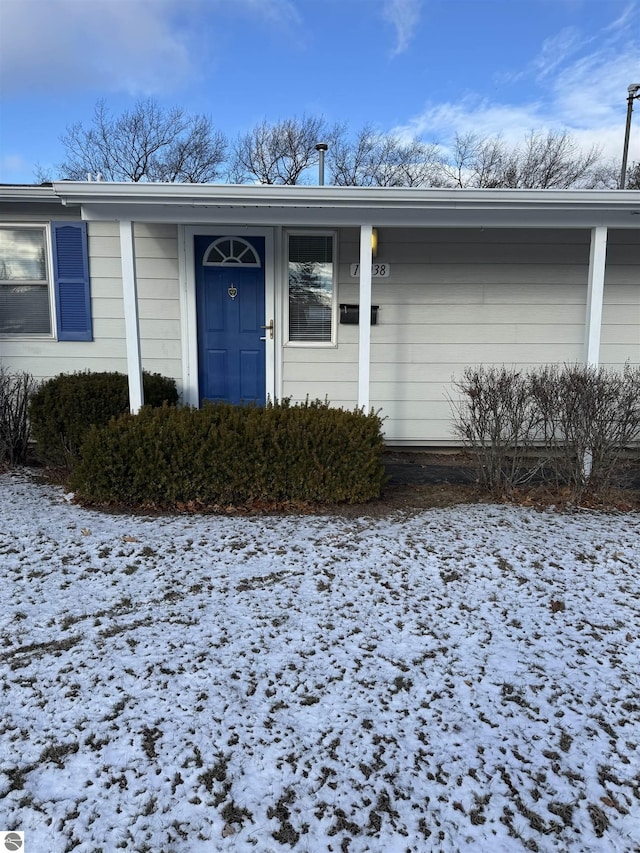 view of snow covered property entrance