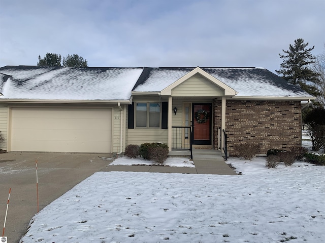 ranch-style home featuring driveway, a garage, and brick siding