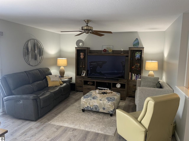 living area featuring ceiling fan and wood finished floors