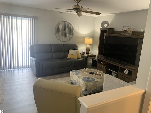 living room with ceiling fan and wood finished floors