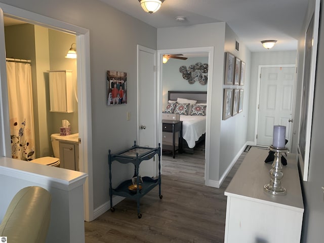 hall with dark wood finished floors and baseboards