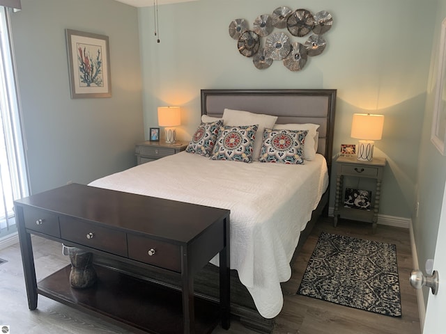 bedroom with wood finished floors and baseboards