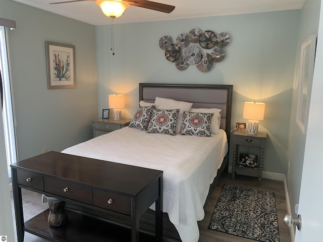 bedroom featuring a ceiling fan, baseboards, and wood finished floors