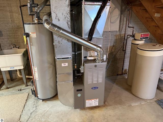 utility room with water heater, a sink, and heating unit