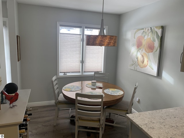 dining space with dark wood-style floors and baseboards