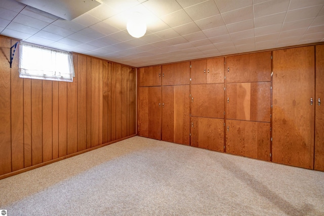 basement featuring light colored carpet