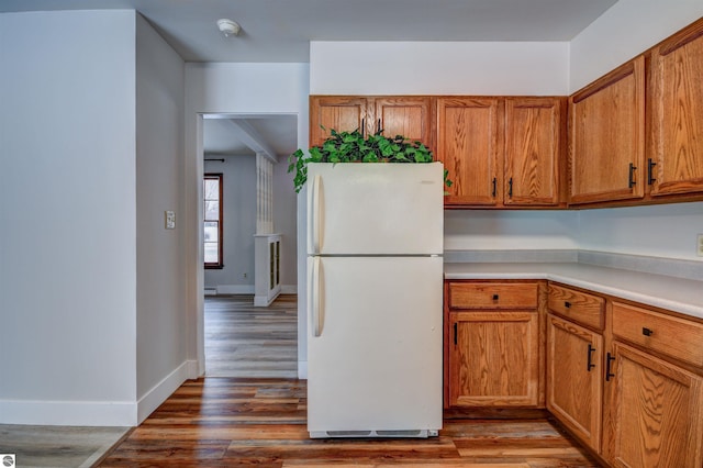 kitchen with white refrigerator and wood-type flooring