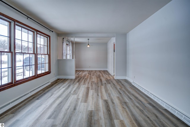 empty room featuring light hardwood / wood-style flooring and baseboard heating