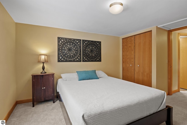 bedroom with light colored carpet and a closet