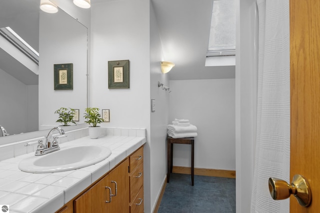 bathroom featuring a skylight and vanity