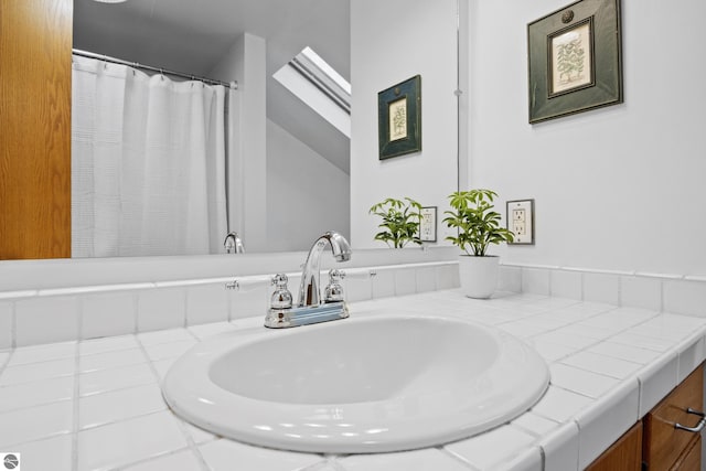 bathroom with vanity and a skylight