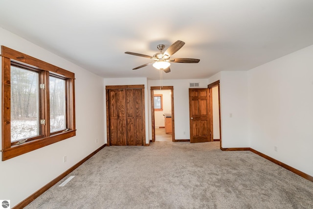 unfurnished bedroom featuring ceiling fan and light colored carpet