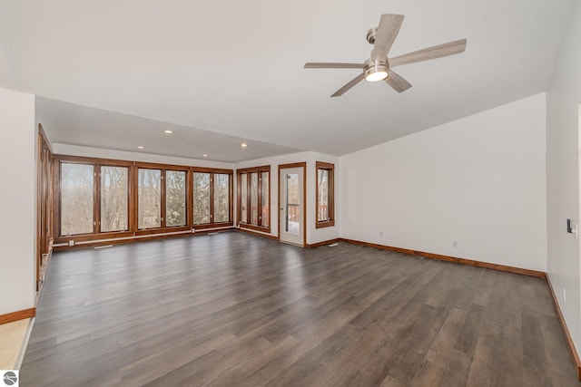 unfurnished living room featuring ceiling fan and dark wood-type flooring