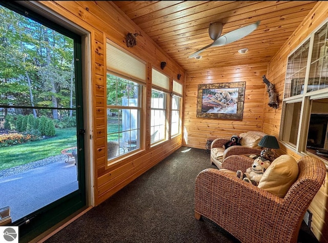 sunroom featuring ceiling fan and wooden ceiling