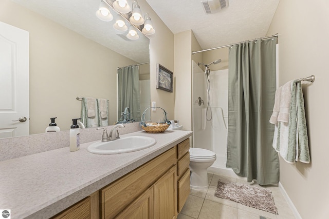 bathroom with tile patterned floors, a shower with curtain, vanity, a textured ceiling, and toilet