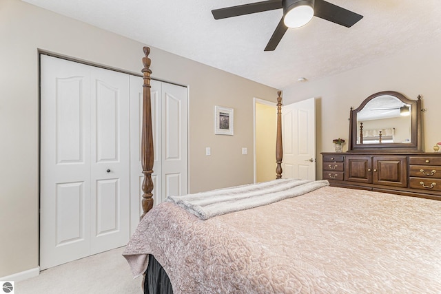 carpeted bedroom with ceiling fan and a closet