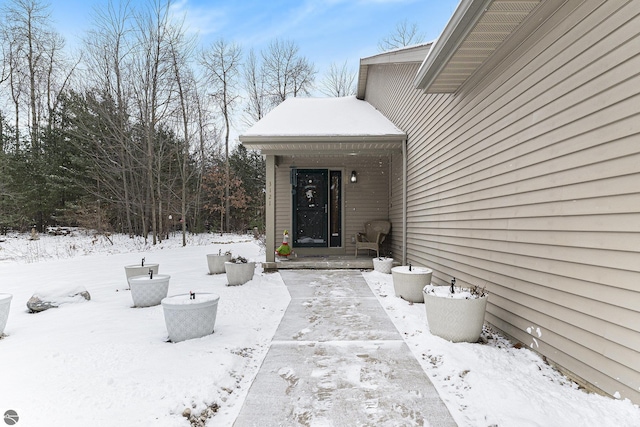 view of snow covered property entrance