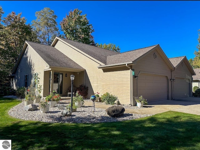 single story home with a garage and a front lawn