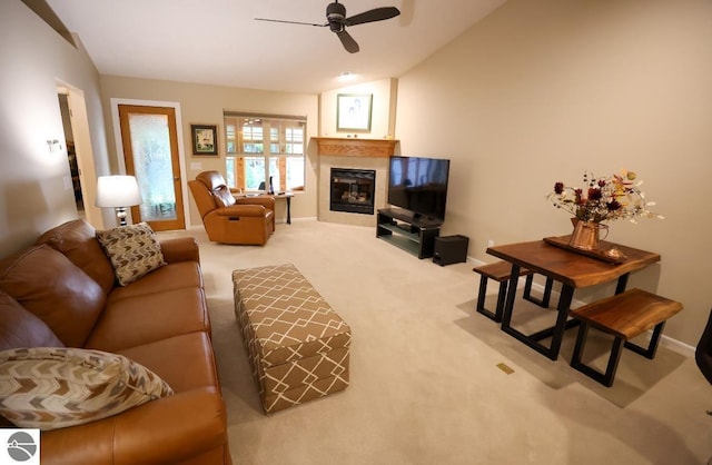 living room featuring carpet floors, vaulted ceiling, and ceiling fan