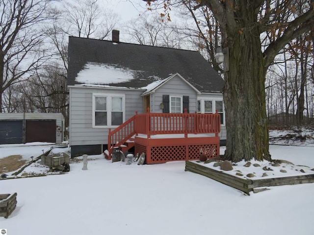 view of front facade with a garage, an outdoor structure, and a deck