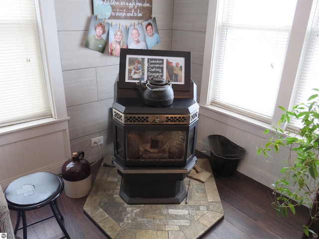 interior details with hardwood / wood-style floors and a wood stove