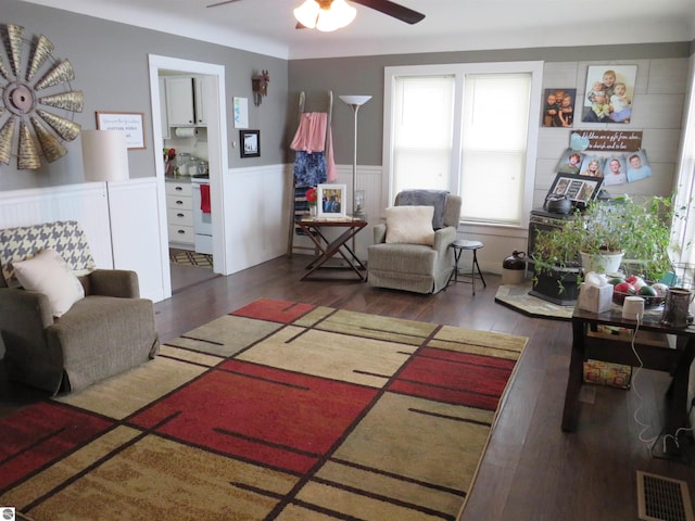 living room featuring dark hardwood / wood-style flooring and ceiling fan