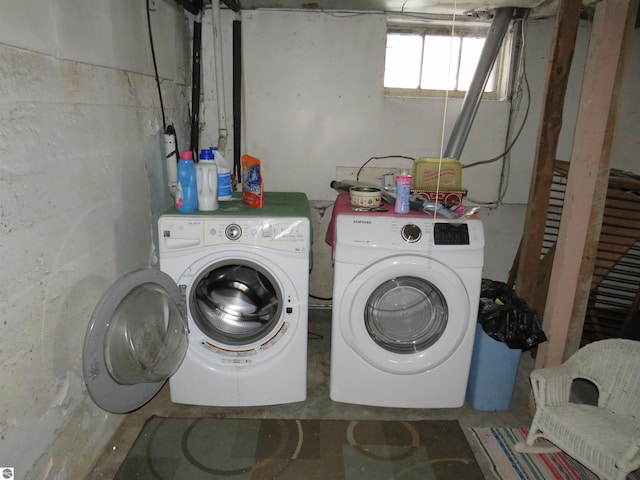 clothes washing area featuring washer and clothes dryer