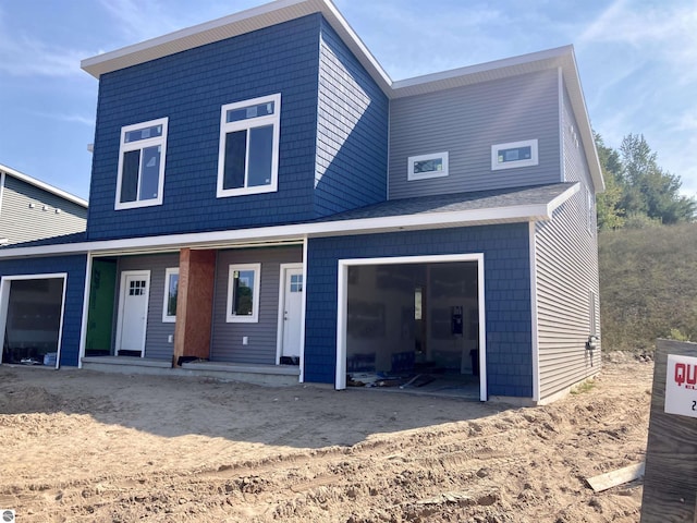 back of property featuring a garage