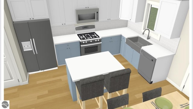 kitchen featuring blue cabinetry, white cabinetry, sink, dishwasher, and stainless steel range with gas cooktop