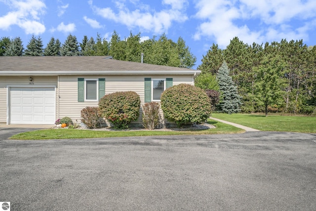 view of side of property with a garage and a lawn