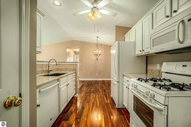 kitchen with white appliances, dark wood-type flooring, sink, decorative light fixtures, and white cabinetry