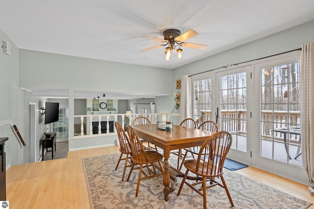 dining space with ceiling fan and light hardwood / wood-style flooring