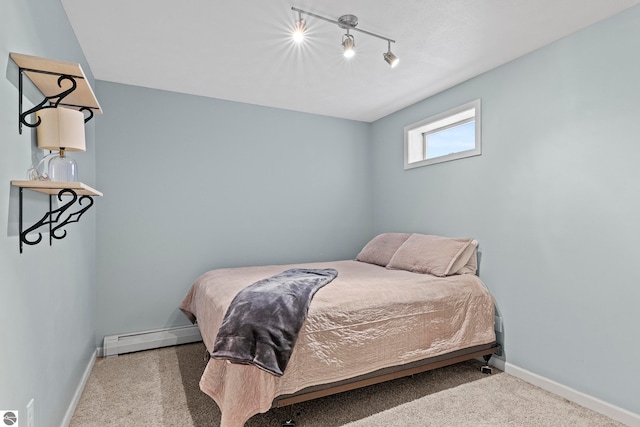 bedroom featuring carpet, a baseboard radiator, and rail lighting