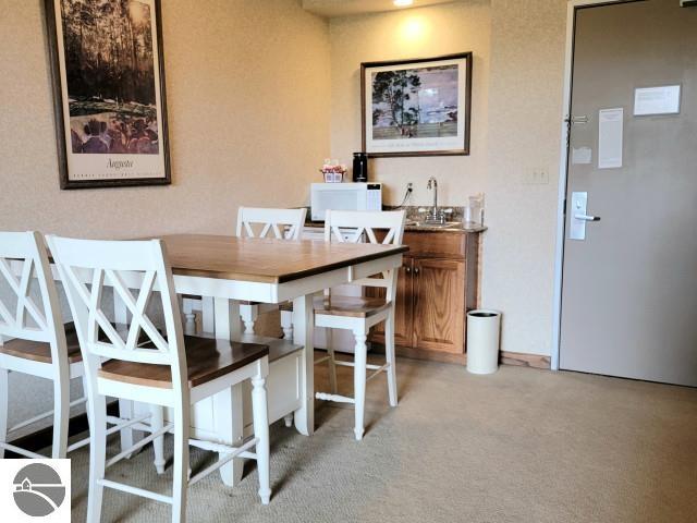 dining area featuring light carpet