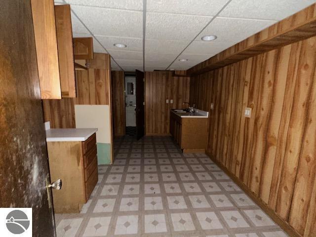 kitchen with sink and wood walls