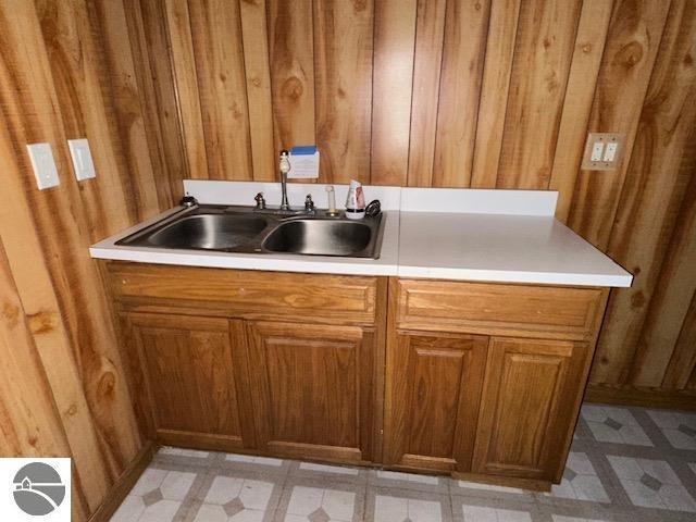 kitchen with wood walls and sink