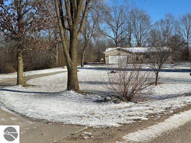 yard covered in snow with a garage