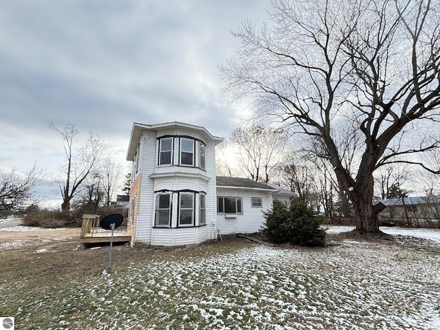 view of snow covered rear of property