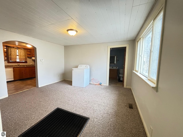 carpeted spare room with wooden ceiling and washer / dryer