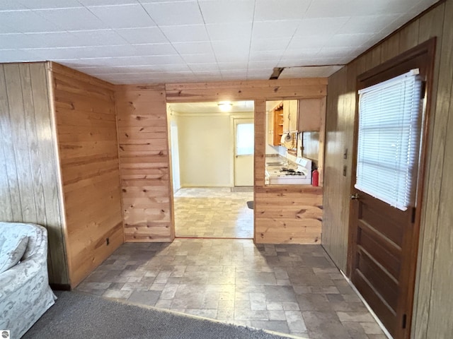 entryway with wood walls