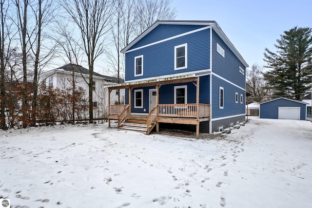 view of front facade featuring a porch, an outdoor structure, and a garage