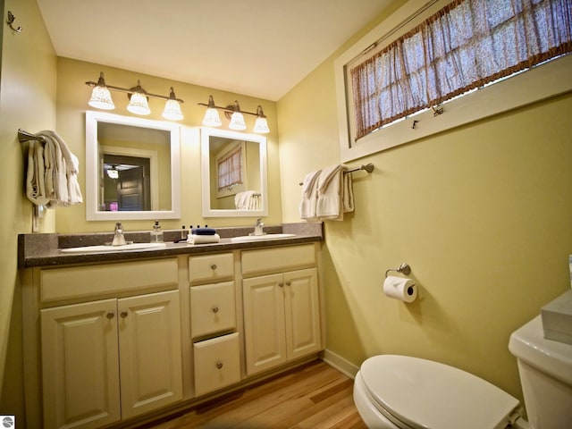 bathroom featuring hardwood / wood-style floors, vanity, and toilet
